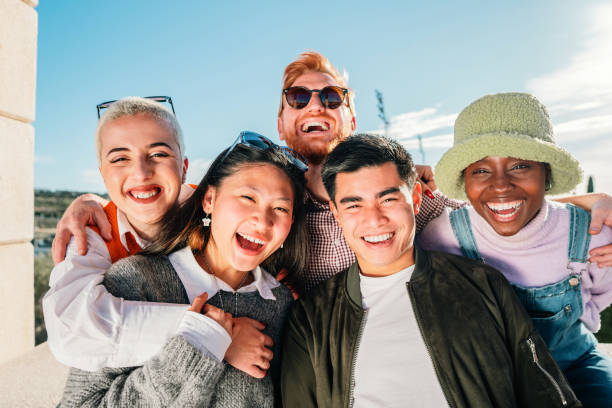 istock Five multi-ethnic friends posing for a photo smiling and having fun outdoor. 1407907724