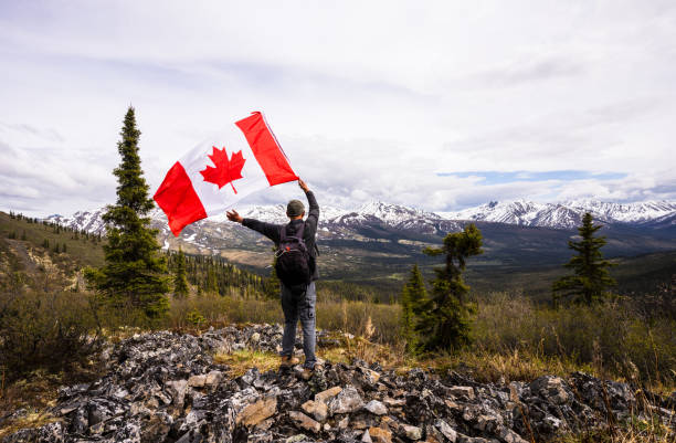 istock Tombstone Territorial Park and man with Canada flag 1407909060