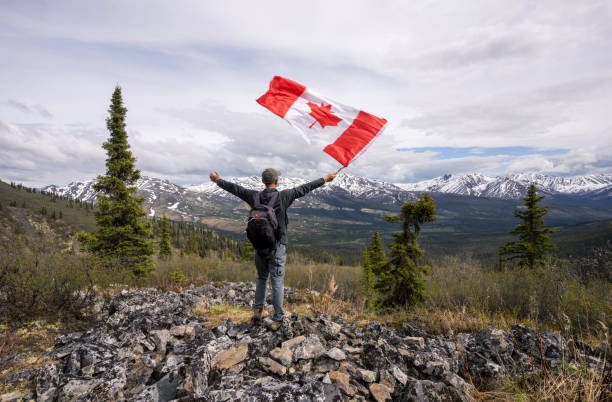 istock Tombstone Territorial Park and man with Canada flag 1407909112