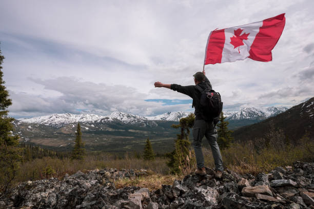 istock Tombstone Territorial Park and man with Canada flag 1407909133