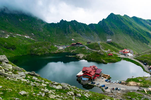 Transfagarasan road, is one of the most beautiful roads in the world. Carpathians. Romania. Chalets on shore Balea Lake is glacier lake in Fagaras Mountains. Transfagarasan mountains road, is one of the most beautiful roads in the world. Beautiful mountains landscape. Carpathians. Romania. balea lake romania stock pictures, royalty-free photos & images