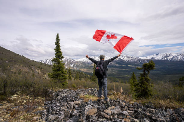 istock Tombstone Territorial Park and man with Canada flag 1407909193
