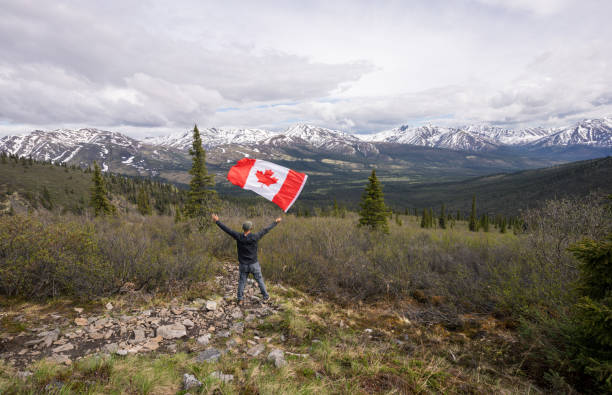 istock Tombstone Territorial Park and man with Canada flag 1407909722