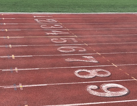 Numbered lanes marked on an all-weather running track