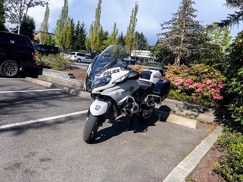 Mill Creek, WA USA - circa May 2022: Angled view of a police motorcycle outside of Mill Creek City Hall.