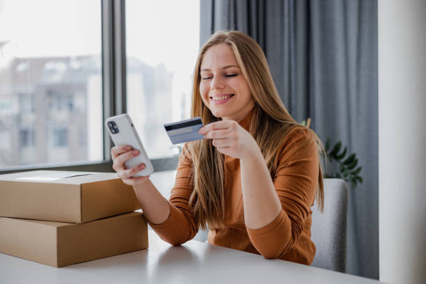 istock Young woman using smart phone to shop online 1407914755