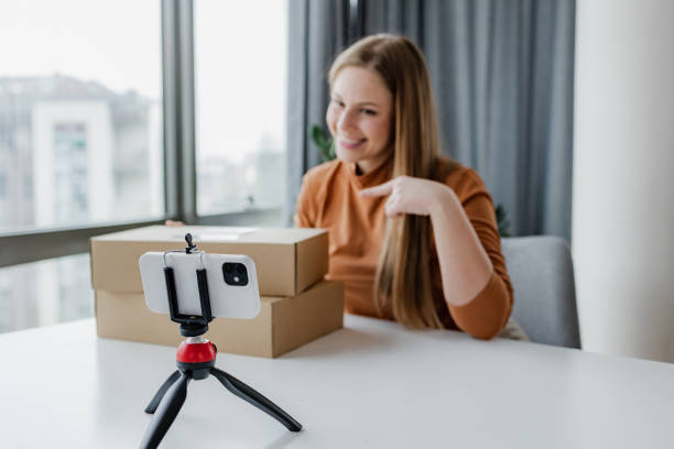 istock Woman vlogging from home about her online purchase 1407916054