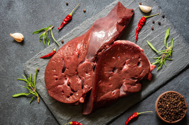 istock Raw Beef liver meat on stone board with thyme and black peppers, cattle giblets 1407918747