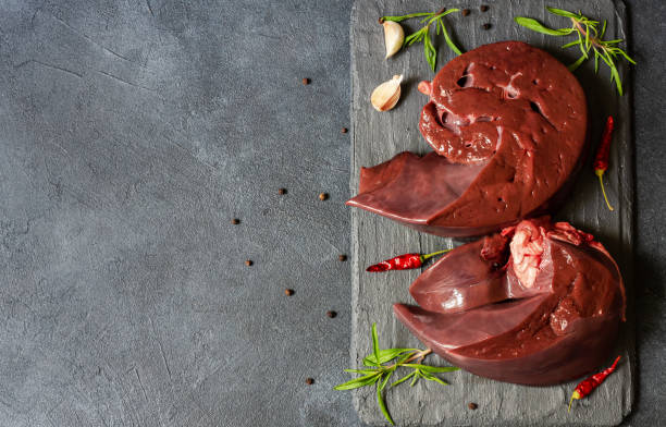 istock Raw Beef liver meat on stone board with thyme and black peppers, cattle giblets 1407918768