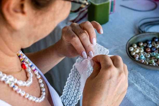 istock Woman is sewing lace bracelet, top view 1407920685
