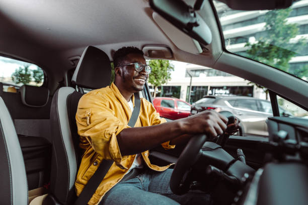 Happy African-American male driver in the car Portrait of smiling African-American man smiling while driving a car black men with blonde hair stock pictures, royalty-free photos & images