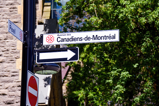 Montreal, Canada - July 3, 2022: Street sign for Avenue des Canadiens-de-Montreal, or Montreal Canadiens avenue. The street is opposite Centre Bell where the NHL team plays. The street was renamed in honor of the team in 2009, the 100th anniversary of the teams existence