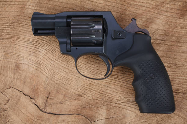 istock Cocked and locked revolver on wooden table 1407923206