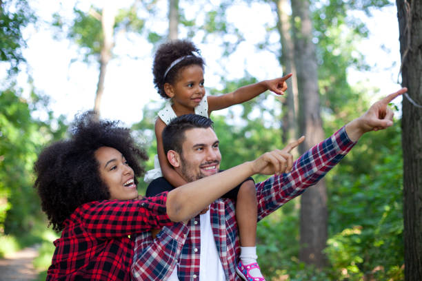 istock Happy family walking along a path in the woods 1407924905