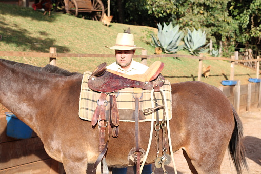 country man riding a mule