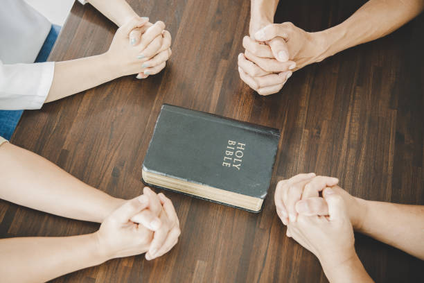 istock Group of people praying worship believe 1407940499