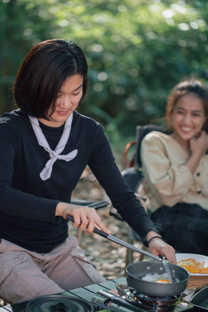 istock young women and her friend cooking fried egg 1407940508