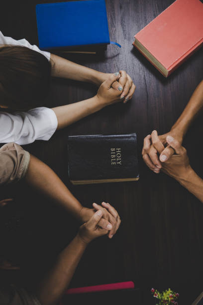 istock Group of people praying worship believe 1407940596