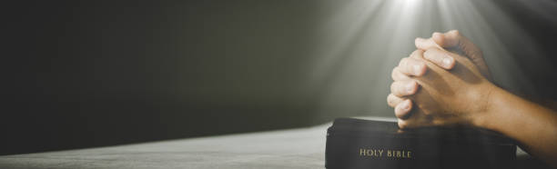 istock Banner image of Hands folded in prayer in church concept 1407940599