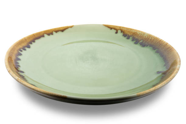 istock Green circle ceramics plate isolated on white background. 1407941212