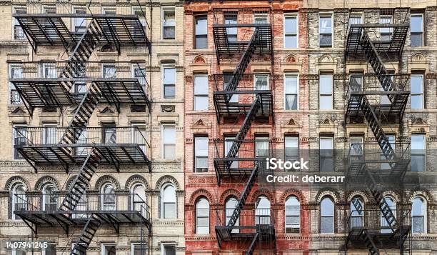 Exterior View Of New York City Style Architecture Apartment Building With Windows And Fire Escapes Stock Photo - Download Image Now