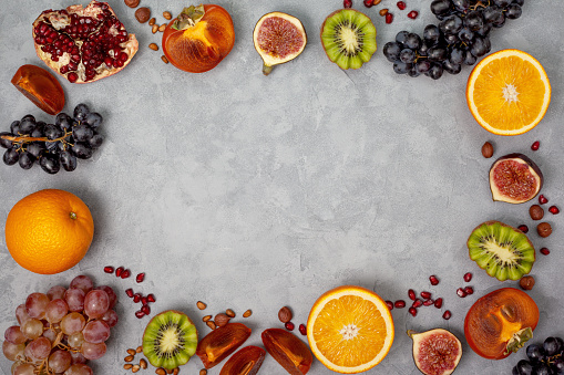 different autumn fruits on a gray concrete background. view from above. copy space