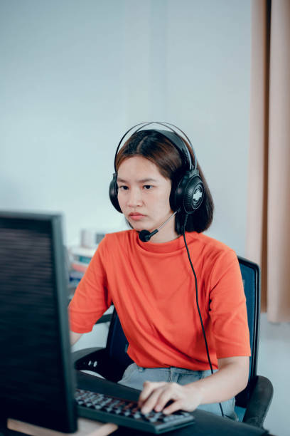 istock Young girl playing computer game on laptop 1407948313