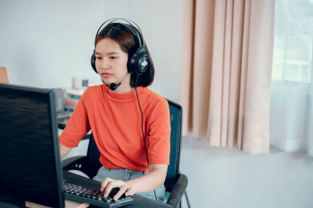istock Young girl playing computer game on laptop 1407948314