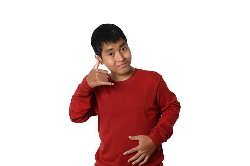 Portrait of young single man making call me gesture, sign with hand shaped like phone isolated on white background. Positive human emotions, face expressions.