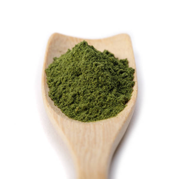 istock Matcha green tea powder in spoon isolated on white background creative flat lay, Organic product from the nature for healthy with traditional style 1407954336