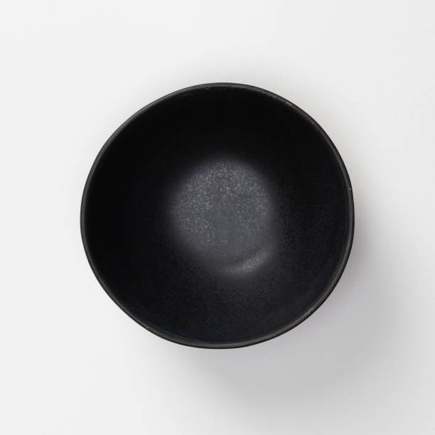 istock Empty blank black ceramic round bowl isolated on white background with shadow, Flat lay of traditional handcrafted kitchenware concept 1407955052