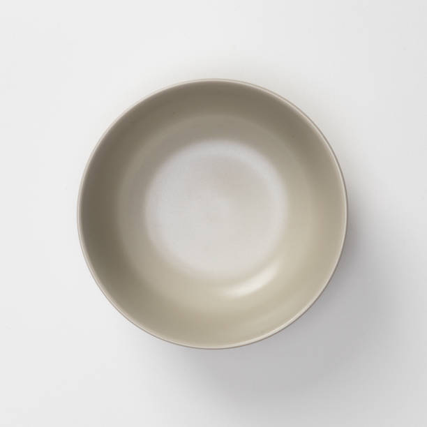 istock Empty blank white ceramic round bowl isolated on white background with shadow, Flat lay of traditional handcrafted kitchenware concept 1407955053