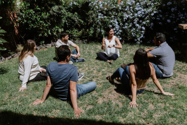 istock hispanic young people seated in circle on grass and participating at group therapy session in Mexico Latin America 1407956289