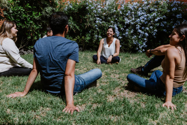 istock hispanic young people seated in circle on grass and participating at group therapy session in Mexico Latin America 1407956350