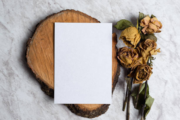 istock Blank card and wilted flowers on marble background 1407957296