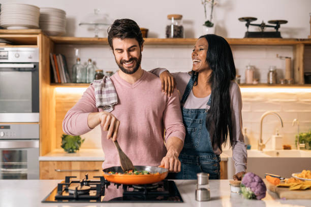 istock Multi-Ethnic Couple Cooking at Home 1407957372
