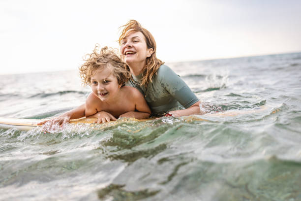 istock Mother and son enjoy surfboarding 1407958695