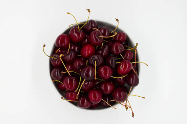Fresh ripe cherries in a bowl isolated on white background. Italian Vignola cherries. stock photo