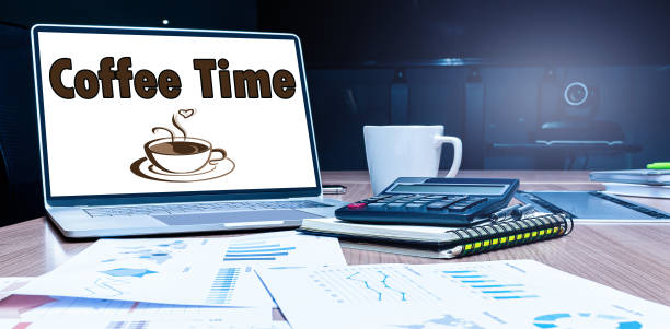 istock Coffee time message and icon coffee cup on display laptop with calculator and paperwork on table in meeting room 1407960902
