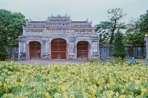 Gate at the Po Lin Monastery, surrounded by the giant Tian Tan Buddha statue, located on Ngong Ping Plateau on Lantau Island, Hong Kong.