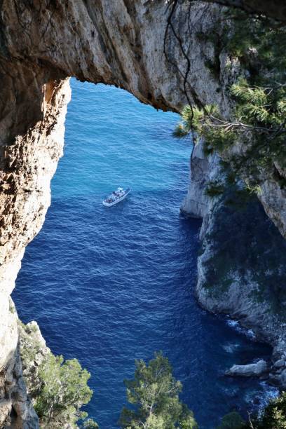 istock Capri - Tourists by boat at the Natural Arch 1407961399