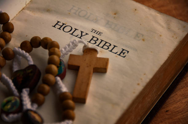 istock Holy Bible and Rosary on a wooden table with customizable space to add ideas or text. Christianity concept. 1407962238