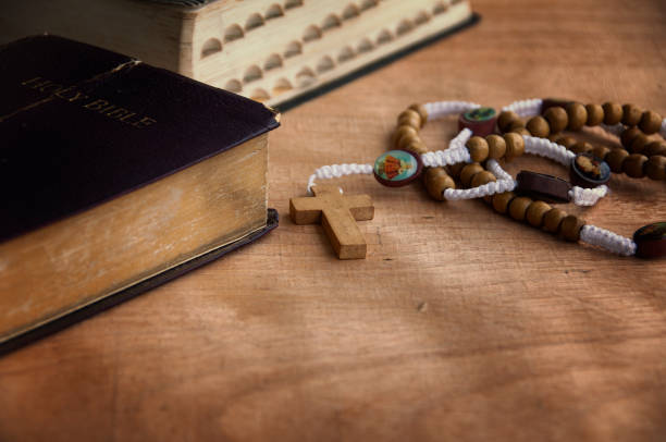istock Holy Bible and Rosary on a wooden table with customizable space to add ideas or text. Christianity concept. 1407962242