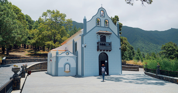 View of a tourist walking to the entrance of a church in La Palma, Canary Islands