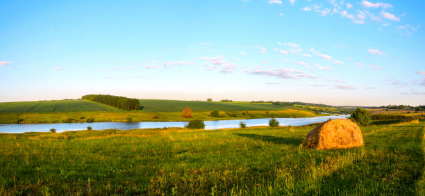 A river winds through the countryside on a hot summer day. River is the Grand River in Waterloo, Ontario, Canada. 