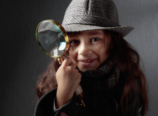 istock Cute little detective with a magnifying glass. 1407967949