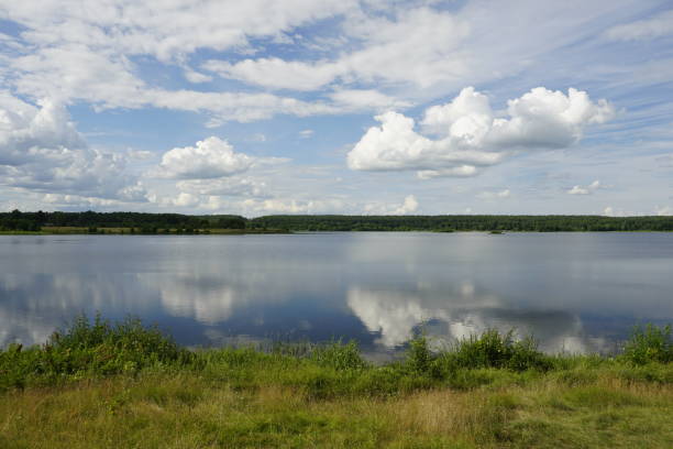 istock White clouds and reflection in the lake. Open spaces. Horizon. Summer 1407969188