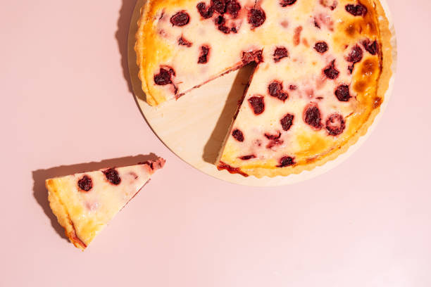istock Piece cut from a whole cherry pie on a wooden board 1407969370