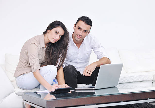 istock couple relax and work on laptop computer at modern home 140797306