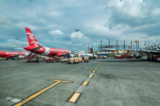 NAIA, Pasay, Metro Manila, Philippines - Nov 2021: An AirAsia Airbus A320-216 being loaded with cargo and loaded with aviation fuel.